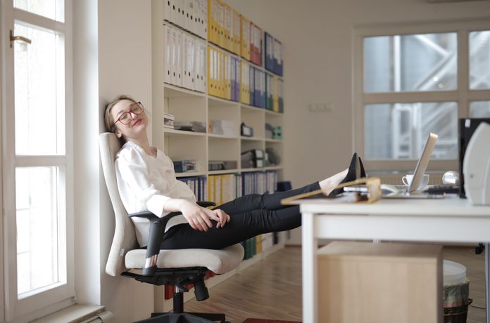 woman-in-office-relaxes-with-feet-on-the-table